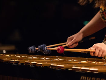 Midsection of woman playing piano