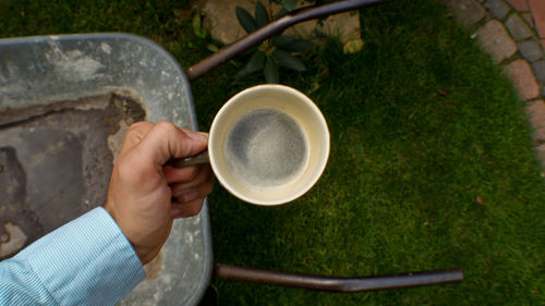 Cropped image of person holding coffee cup