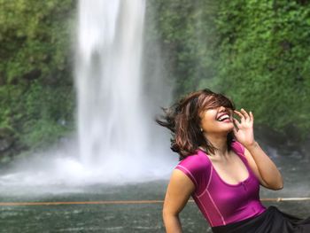 Beautiful woman against waterfall