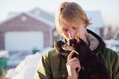 Portrait of young man with dog