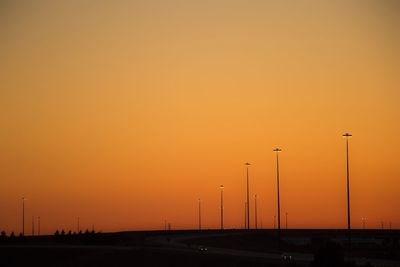 Road against clear sky at sunset