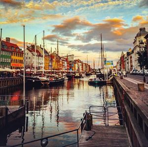 Boats in harbor at sunset