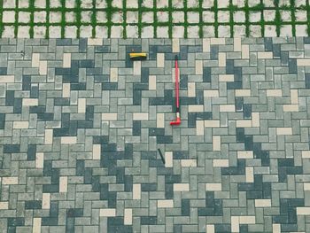 High angle view of broken brush on footpath