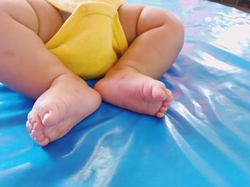 Low section of baby feet on bed