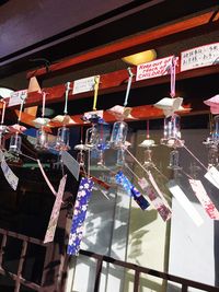 Low angle view of illuminated lanterns hanging against sky at night