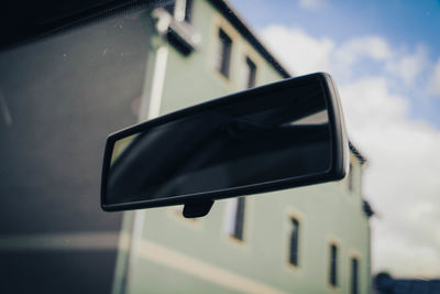 Close-up of car on road against sky