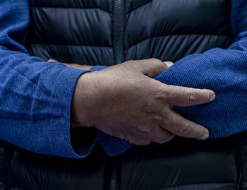 Midsection of man wearing gloves