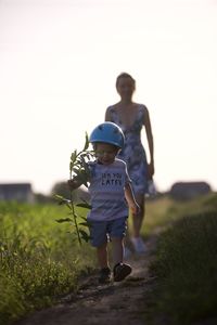 Rear view of man standing on field