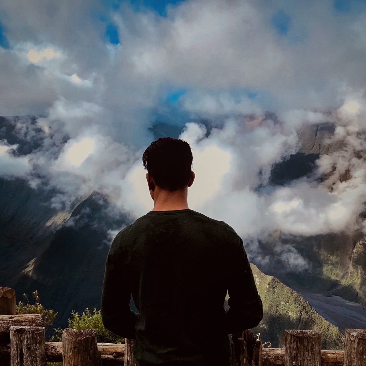 rear view, cloud - sky, one person, real people, sky, leisure activity, men, lifestyles, standing, smoke - physical structure, nature, mountain, casual clothing, waist up, day, beauty in nature, looking at view, three quarter length, scenics - nature, outdoors