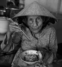 Portrait of senior woman having noodles at home
