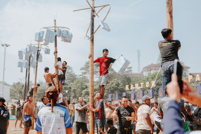 People standing on street against sky