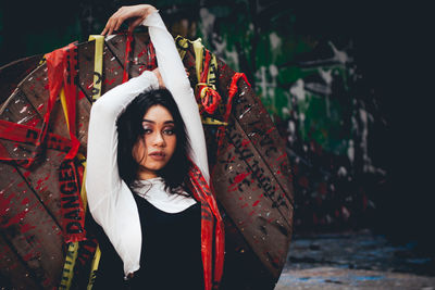 Portrait of female model posing wooden spool