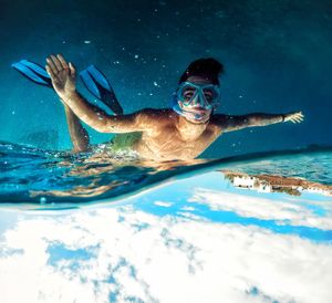 Portrait of young woman swimming in pool