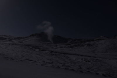 Scenic view of landscape against sky at night