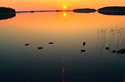 Scenic view of lake at sunset