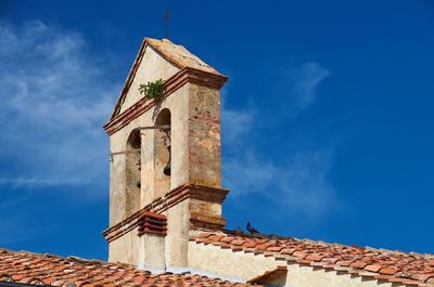 Low angle view of bell tower against sky