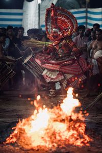 Statue of people with fire in background