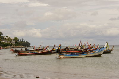 Boats on shore against sky