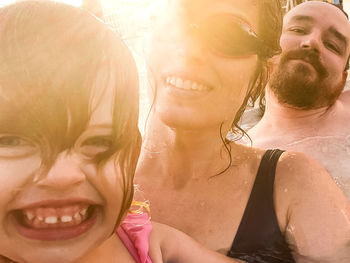 Portrait of smiling woman with swimming pool