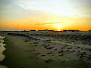 Scenic view of beach against sky during sunset