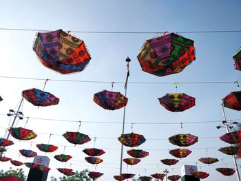 Low angle view of lanterns hanging against clear sky