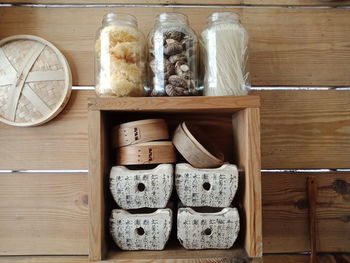 Food in jars on rack against wall