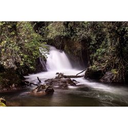 Scenic view of river flowing through rocks