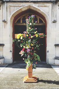 Flowers on cross at entrance of church