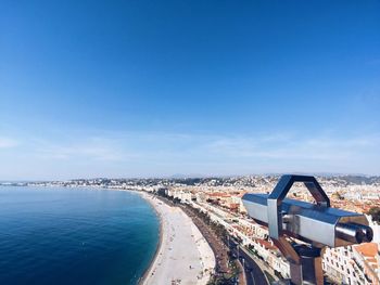 Aerial view of cityscape against blue sky