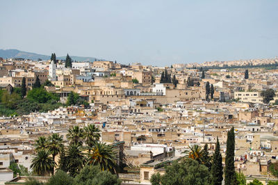 Buildings in city against clear sky