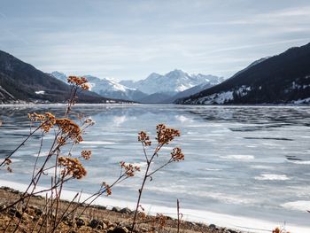 Scenic view of lake and snowcapped mountains against sky