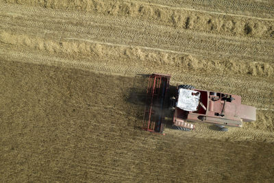 Aerial photographic documentation of the work of a grain harvester during the summer season