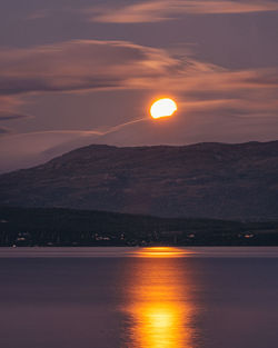 Scenic view of sea against orange sky