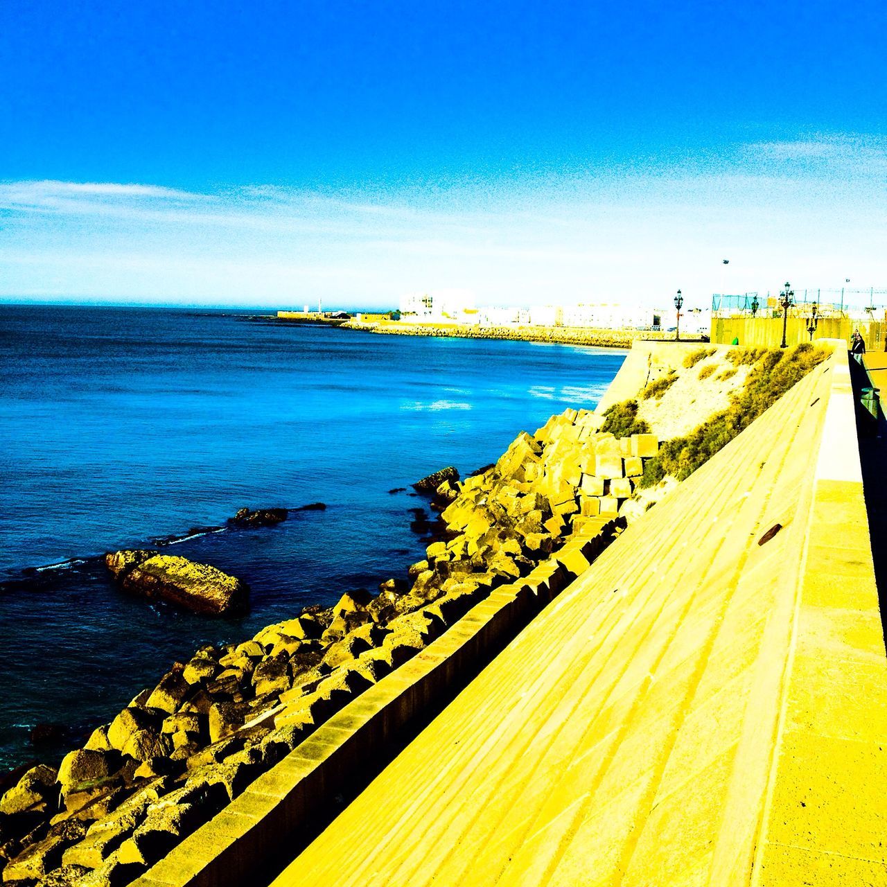 sea, water, blue, horizon over water, clear sky, transportation, copy space, nautical vessel, tranquil scene, scenics, tranquility, pier, mode of transport, beauty in nature, nature, sky, incidental people, beach, boat, day