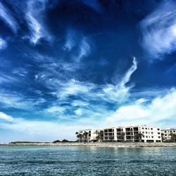 Houses against cloudy sky