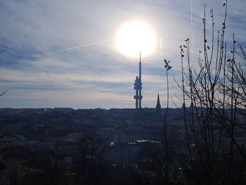 Silhouette of city against sky during sunset