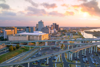 High angle view of road by buildings against sky during sunset