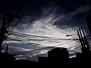 Low angle view of building against cloudy sky