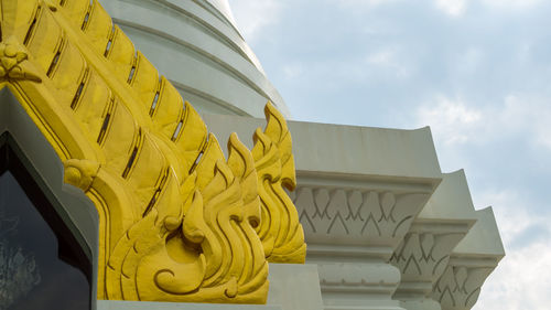 Low angle view of yellow built structure against sky