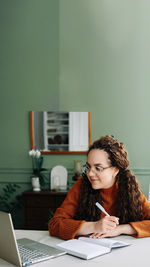 Young woman using laptop at home