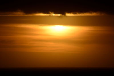 Scenic view of sea against romantic sky at sunset