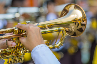 Cropped hands of musician playing trumpet during music festival