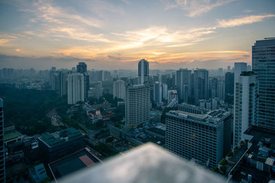 High angle view of modern buildings against sky during sunset