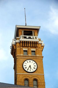 Low angle view of clock tower against sky