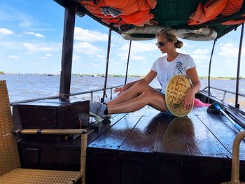 Woman sitting in boat on river