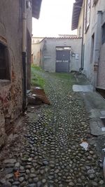 Footpath amidst buildings in city