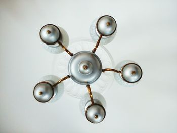 Low angle view of illuminated chandelier hanging from ceiling