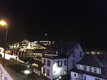 Illuminated buildings against sky at night