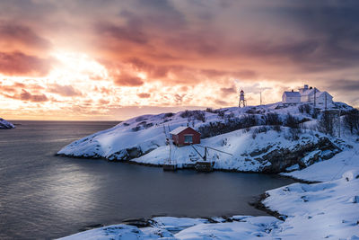 Scenic view of frozen sea against sky during sunset