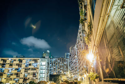Illuminated buildings against sky at night